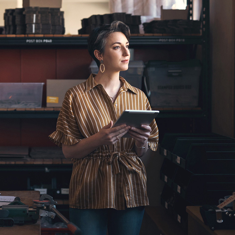 Woman in warehouse prepping shipping items